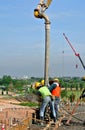 Construction Workers Using Concrete Hose from Concrete Pump